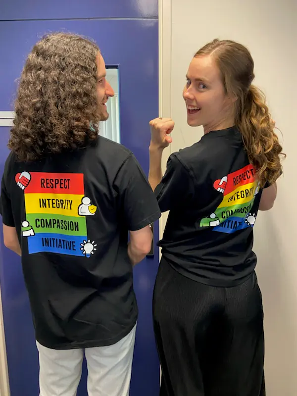 Education staff wearing black shirts with colourful DTF printed values graphics