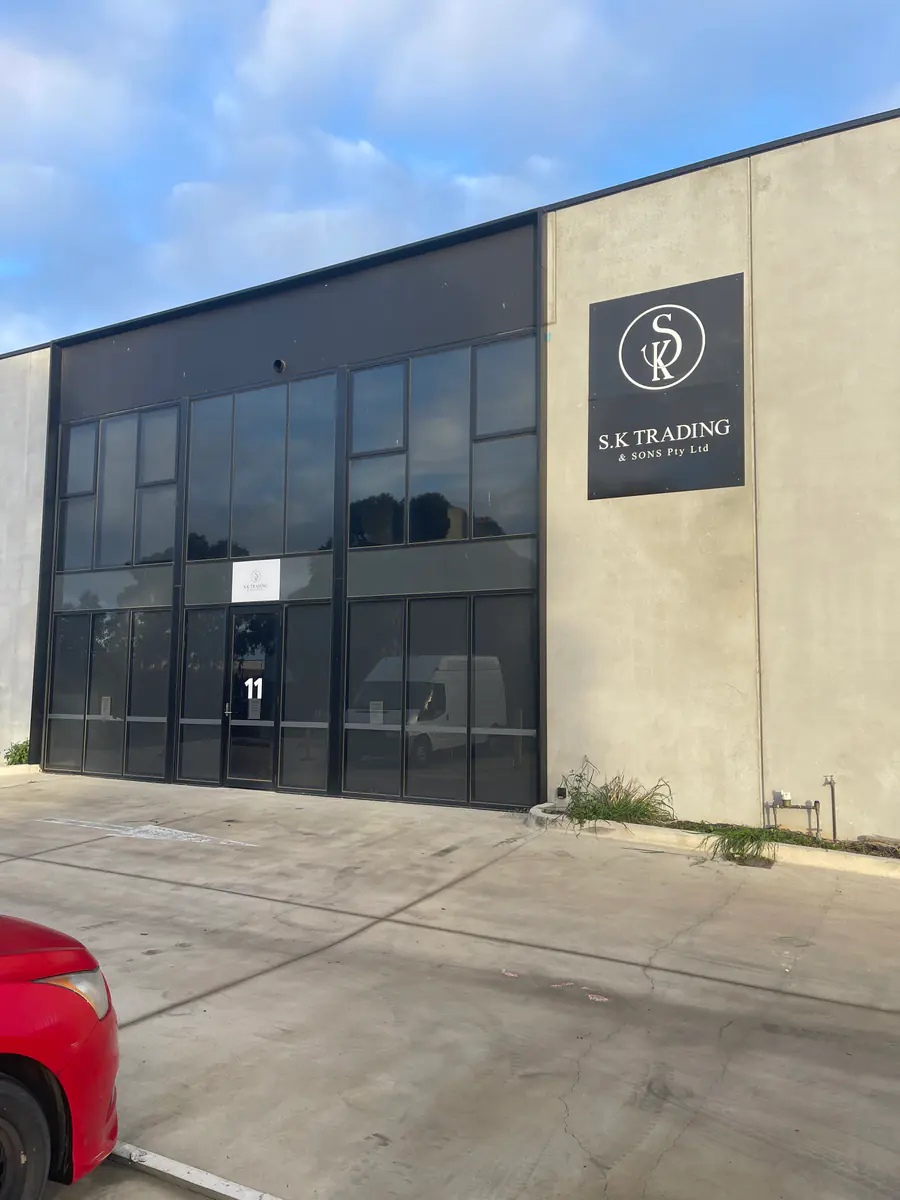 Black industrial building identification sign installed on a warehouse exterior